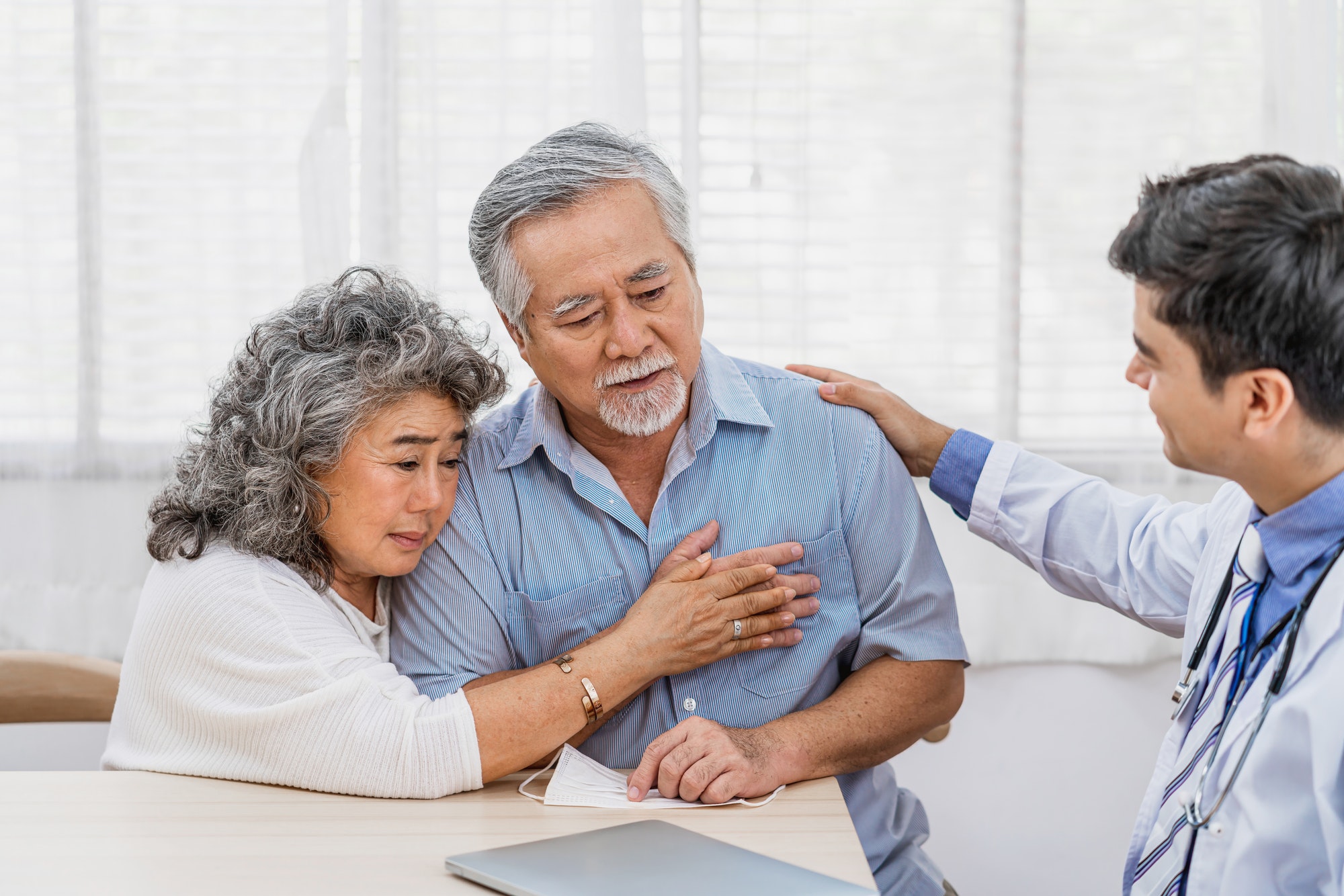 Doctor using stethoscope for auscultate Asian grandparent patient in house, service Life insurance